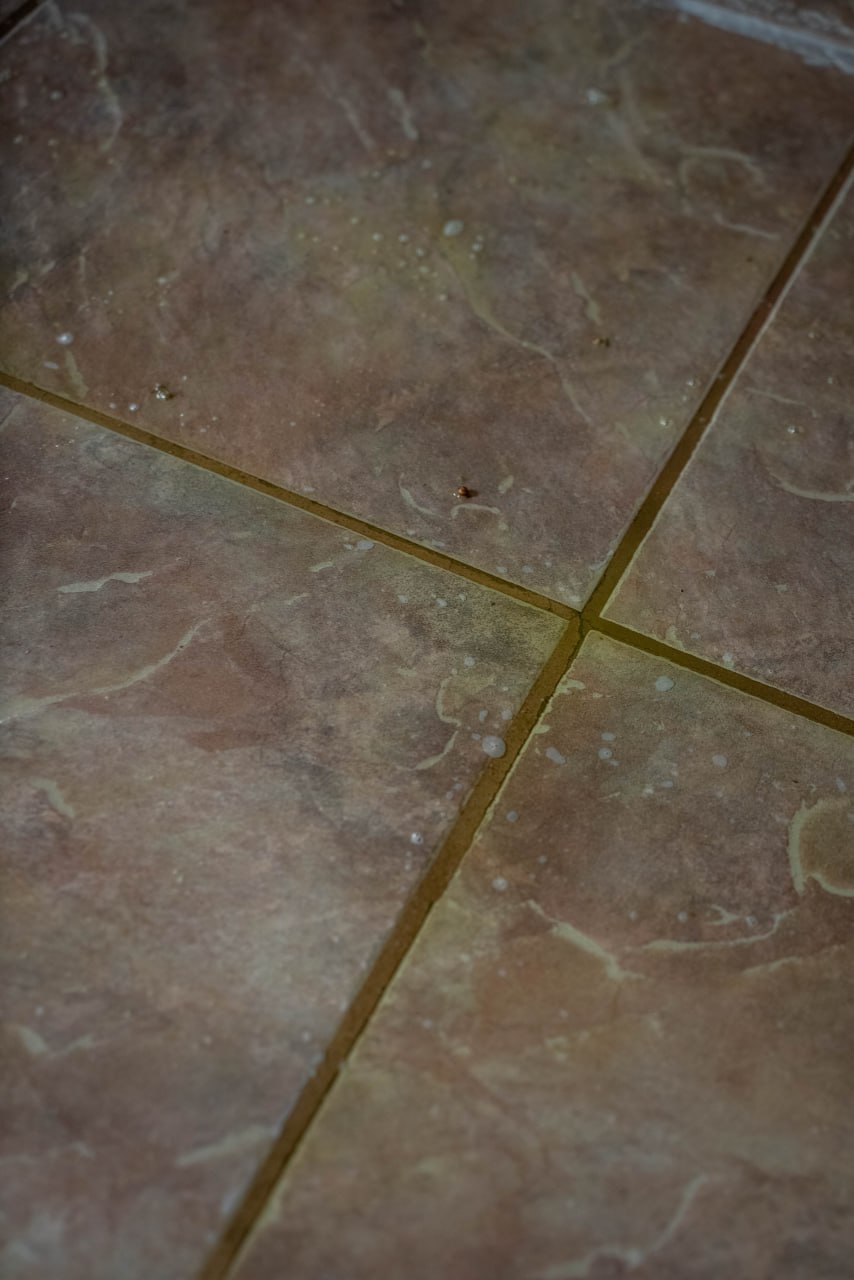 Before professional grout cleaning — stained and discolored grout lines