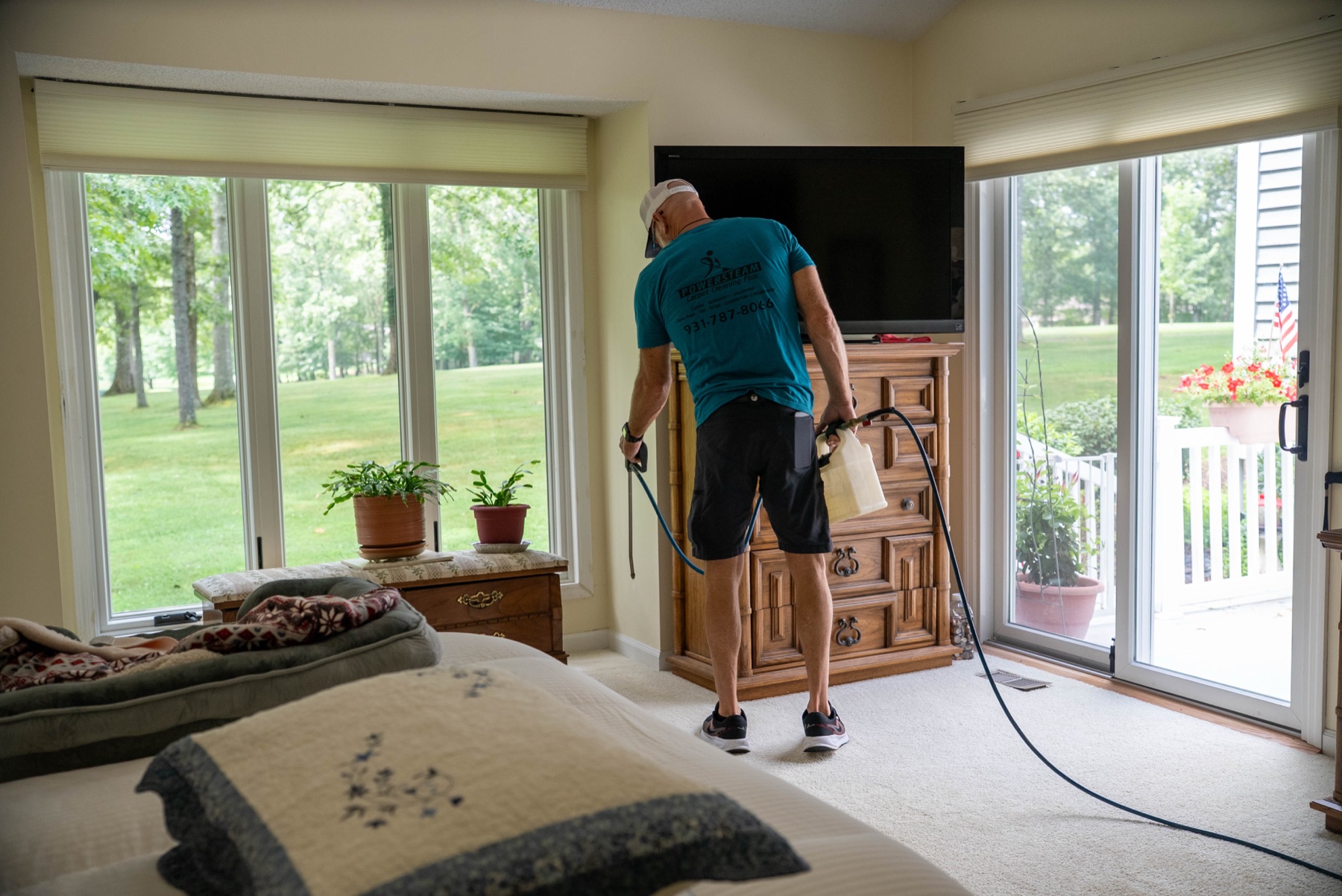 PowerSteam technician cleaning carpet with a professional wand
